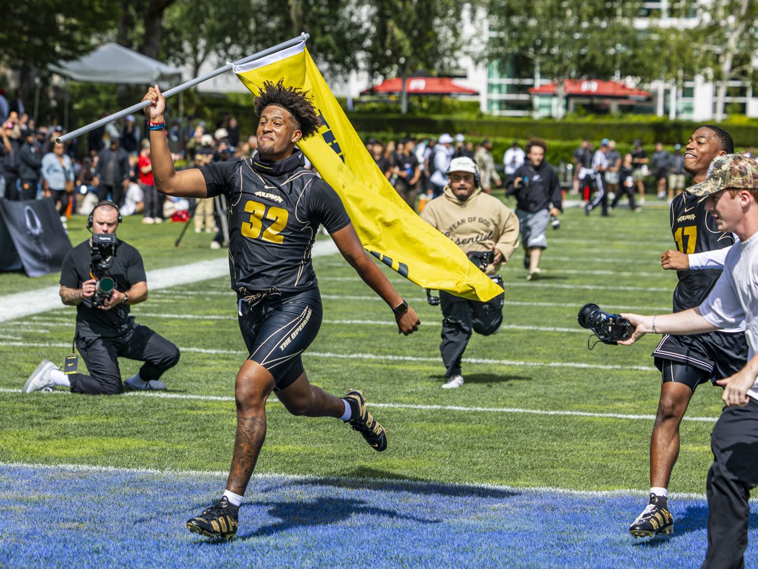 Athlete running with a flag at The Opening